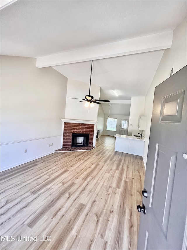 7164 Kimlee Cv, Southaven, MS 38671 - unfurnished living room with a ceiling fan, light wood finished floors, a fireplace, and baseboards
