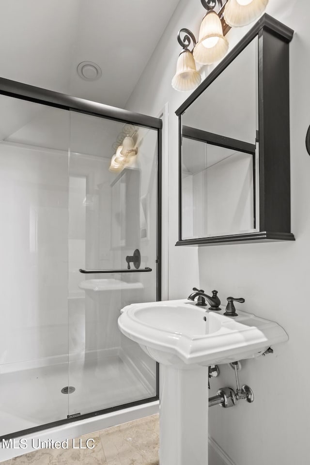 bathroom with a shower with shower door