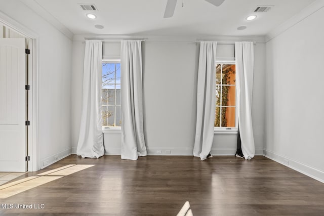 empty room with ceiling fan, dark hardwood / wood-style flooring, and ornamental molding