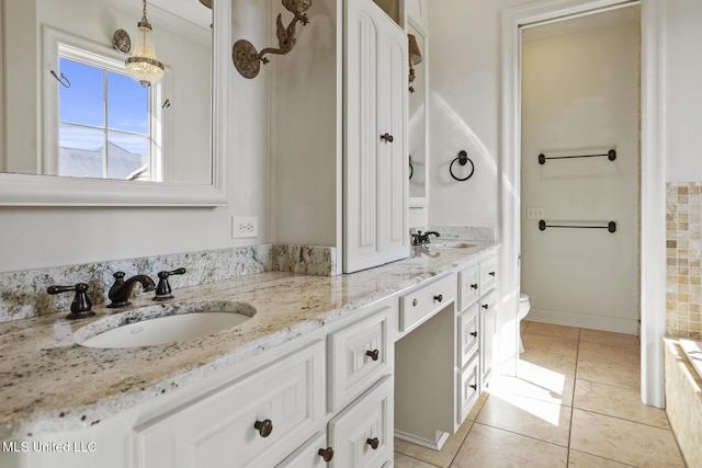 bathroom featuring tile patterned flooring, vanity, and toilet