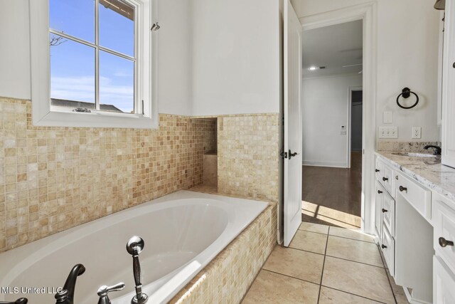 bathroom featuring vanity, tile patterned floors, crown molding, tile walls, and tiled tub