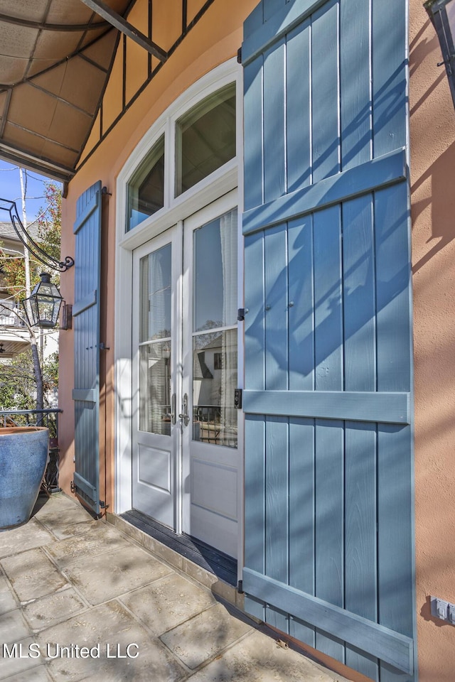 view of exterior entry featuring french doors