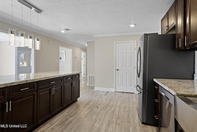 kitchen with hanging light fixtures, light hardwood / wood-style floors, crown molding, appliances with stainless steel finishes, and dark brown cabinetry