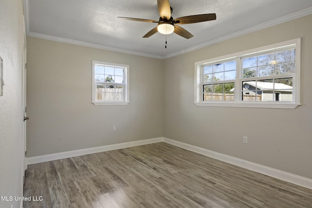 empty room featuring a textured ceiling, ceiling fan, hardwood / wood-style flooring, and ornamental molding