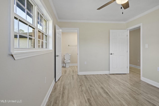 interior space featuring ensuite bathroom, ceiling fan, ornamental molding, and light hardwood / wood-style flooring