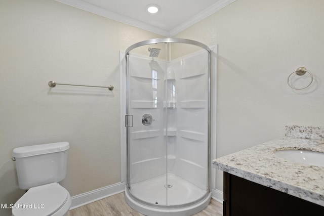 bathroom with toilet, walk in shower, crown molding, vanity, and hardwood / wood-style flooring