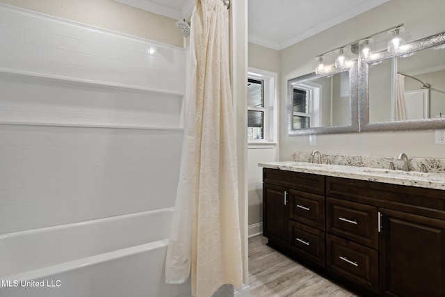 bathroom with hardwood / wood-style floors, crown molding, vanity, and shower / bath combo