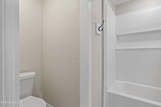 bathroom with toilet and a tub