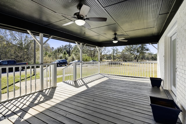 wooden terrace with a yard and ceiling fan