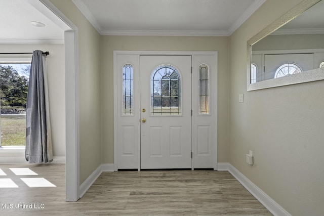 entryway featuring crown molding and a healthy amount of sunlight