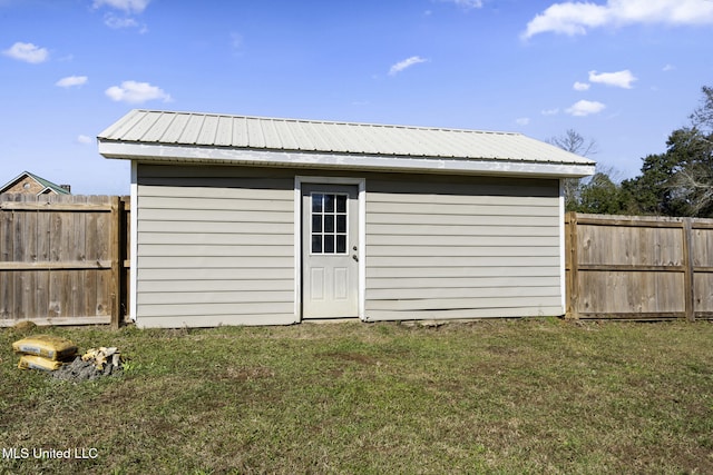 view of outbuilding featuring a yard