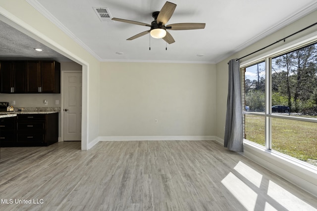 unfurnished living room with ceiling fan, crown molding, and light hardwood / wood-style flooring