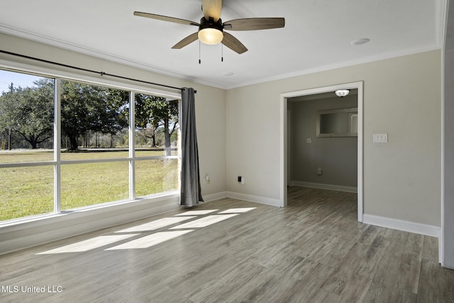 unfurnished room featuring light wood-type flooring, ceiling fan, crown molding, and a wealth of natural light