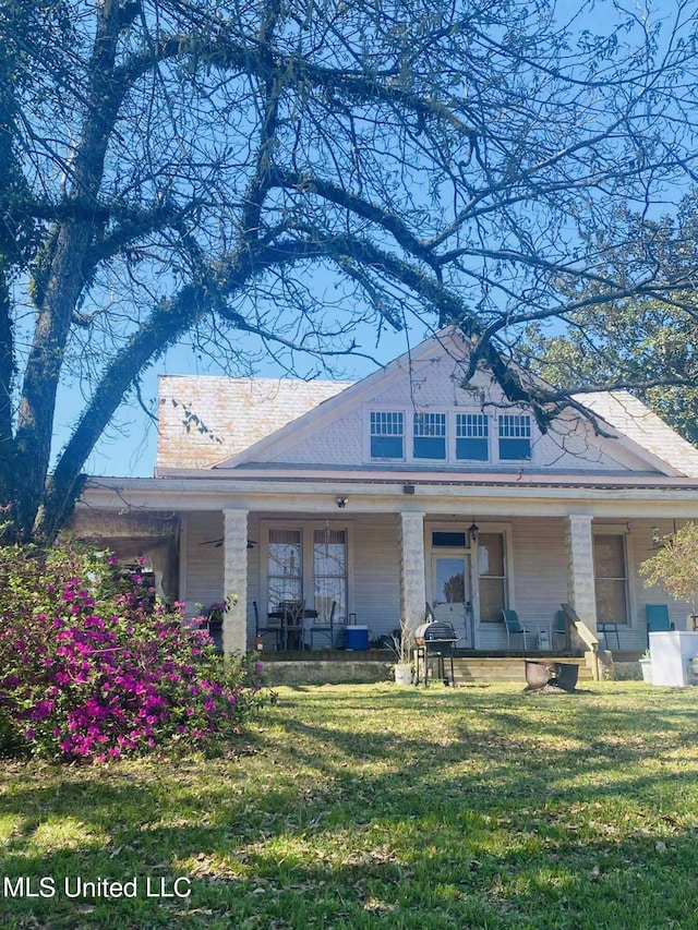 exterior space with a porch and a front lawn