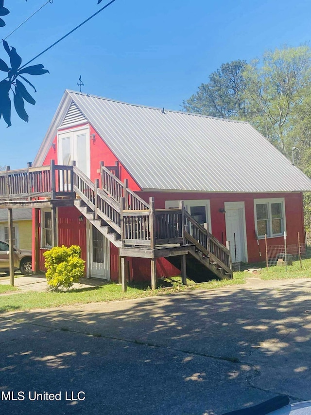 rear view of house with a wooden deck