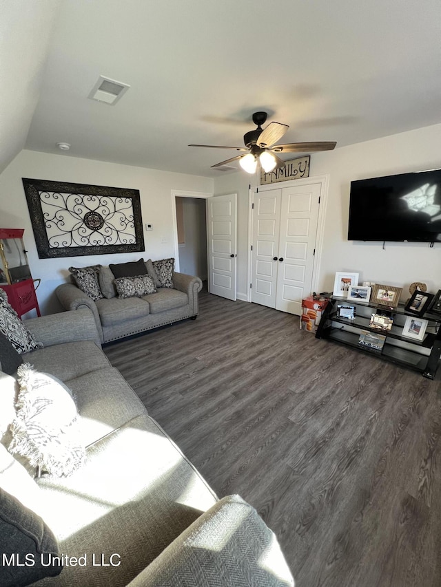 living room with ceiling fan, dark wood-style floors, and visible vents