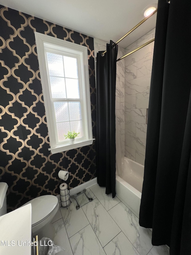 bathroom with shower / bath combo, toilet, marble finish floor, baseboards, and wallpapered walls
