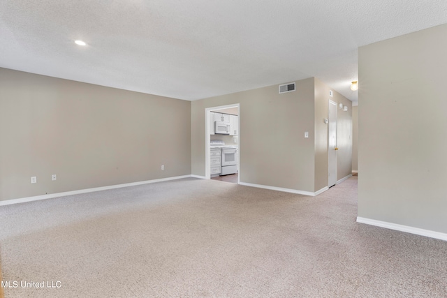 carpeted spare room featuring a textured ceiling