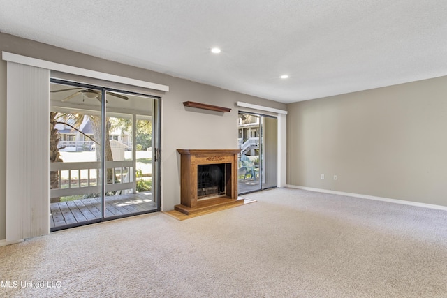 295 Highpoint Dr, Diamondhead, MS 39525 - unfurnished living room featuring baseboards, recessed lighting, a fireplace, and carpet
