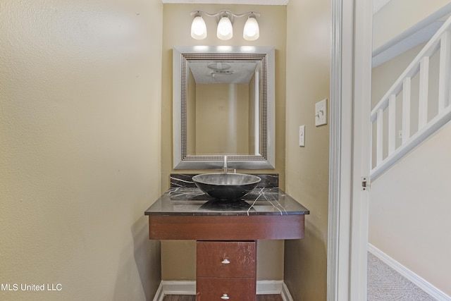 295 Highpoint Dr, Diamondhead, MS 39525 - bathroom featuring baseboards and a sink