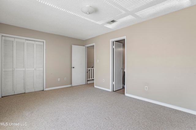 unfurnished bedroom with light colored carpet and a closet