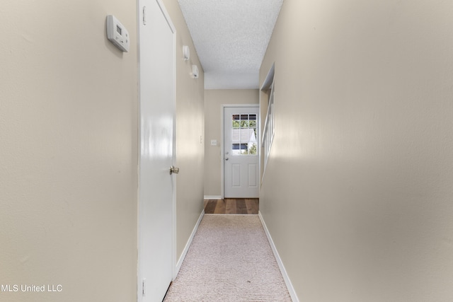 295 Highpoint Dr, Diamondhead, MS 39525 - corridor featuring baseboards, a textured ceiling, and carpet flooring