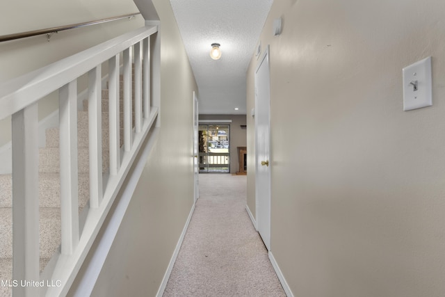 295 Highpoint Dr, Diamondhead, MS 39525 - corridor featuring a textured ceiling, carpet floors, and baseboards