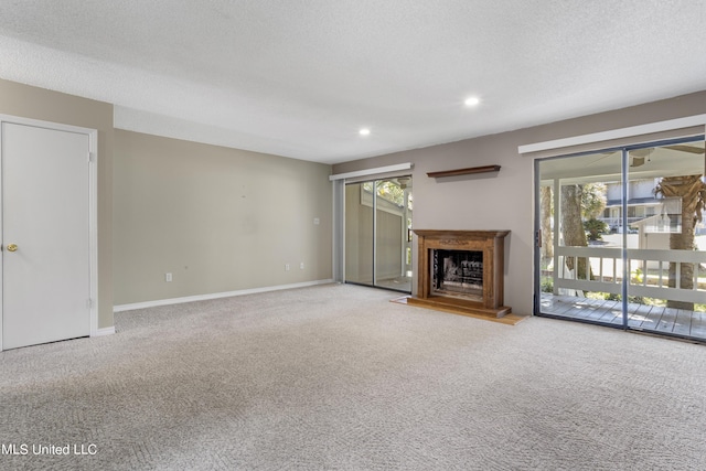 295 Highpoint Dr, Diamondhead, MS 39525 - unfurnished living room with carpet, a wealth of natural light, a fireplace with raised hearth, and recessed lighting
