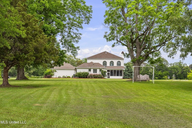 1053 Woodbridge Dr, Brandon, MS 39047 - back of house with a yard and a sunroom