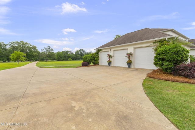 1053 Woodbridge Dr, Brandon, MS 39047 - view of home's exterior with a lawn, concrete driveway, a shingled roof, and an attached garage
