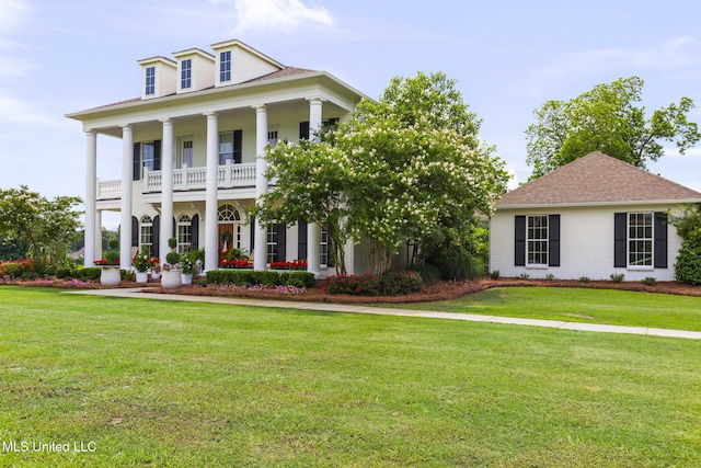 1053 Woodbridge Dr, Brandon, MS 39047 - greek revival house featuring a porch, a front lawn, a balcony, and a shingled roof