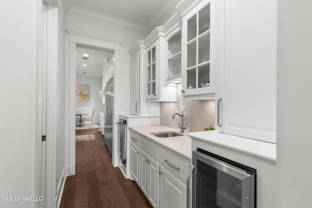 1053 Woodbridge Dr, Brandon, MS 39047 - indoor wet bar with beverage cooler, ornamental molding, dark wood-style flooring, and backsplash