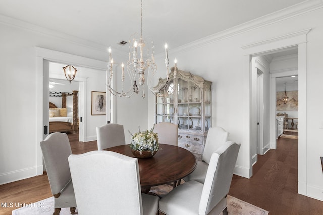 1053 Woodbridge Dr, Brandon, MS 39047 - dining room with a chandelier, wood finished floors, ornamental molding, and baseboards