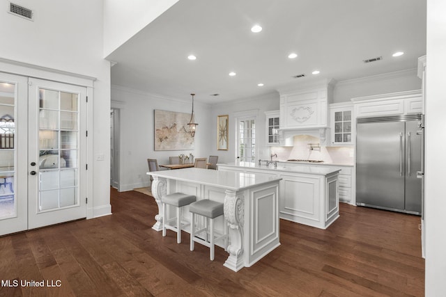 1053 Woodbridge Dr, Brandon, MS 39047 - kitchen featuring built in fridge, a center island, french doors, ornamental molding, and light countertops