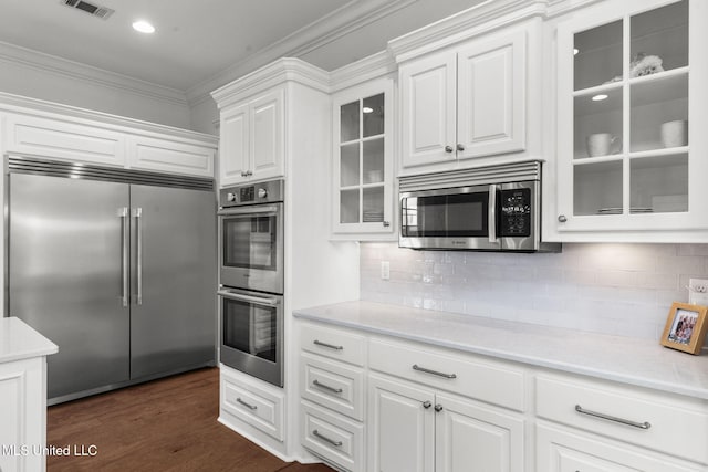 1053 Woodbridge Dr, Brandon, MS 39047 - kitchen featuring stainless steel appliances, crown molding, light countertops, white cabinets, and glass insert cabinets