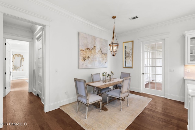1053 Woodbridge Dr, Brandon, MS 39047 - dining room featuring dark wood-type flooring, ornamental molding, and baseboards