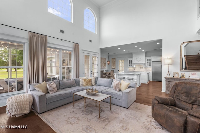 1053 Woodbridge Dr, Brandon, MS 39047 - living room with crown molding, healthy amount of natural light, wood finished floors, french doors, and a high ceiling