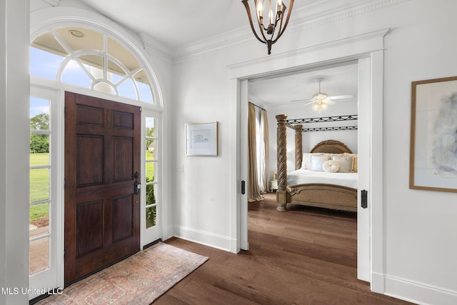 1053 Woodbridge Dr, Brandon, MS 39047 - entrance foyer with baseboards, a chandelier, dark wood-style floors, crown molding, and ceiling fan