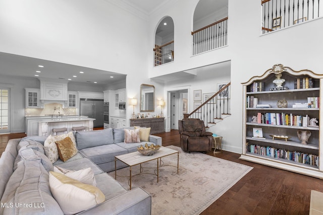 1053 Woodbridge Dr, Brandon, MS 39047 - living area with ornamental molding, dark wood-type flooring, baseboards, stairs, and recessed lighting