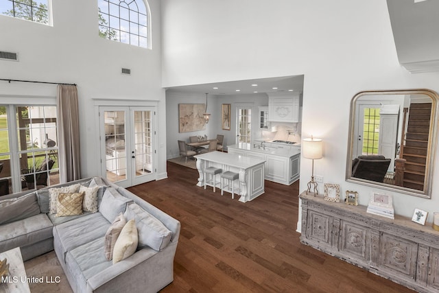 1053 Woodbridge Dr, Brandon, MS 39047 - living area with french doors, a high ceiling, and dark wood-type flooring