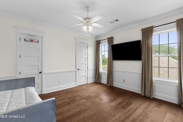 1053 Woodbridge Dr, Brandon, MS 39047 - bedroom featuring wood finished floors, wainscoting, multiple windows, crown molding, and a ceiling fan