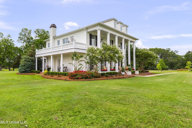 1053 Woodbridge Dr, Brandon, MS 39047 - view of front of house featuring a balcony, a front lawn, a chimney, and a porch