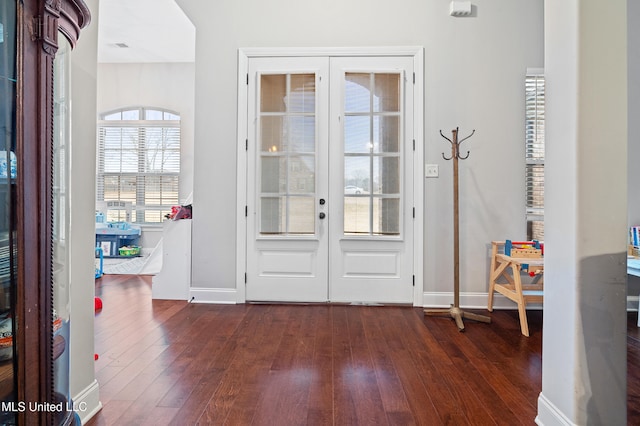 foyer featuring dark hardwood / wood-style flooring and french doors