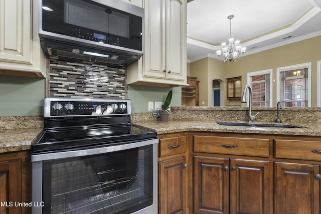 5578 E Diamondhead Dr, Diamondhead, MS 39525 - kitchen featuring stainless steel appliances, a sink, tasteful backsplash, a chandelier, and crown molding