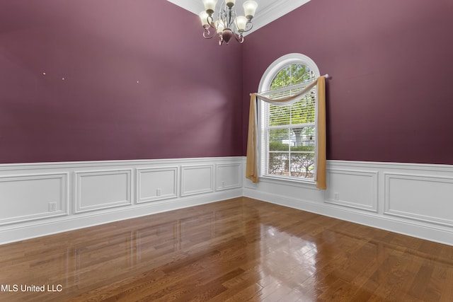 5578 E Diamondhead Dr, Diamondhead, MS 39525 - spare room featuring a chandelier, wainscoting, and wood finished floors