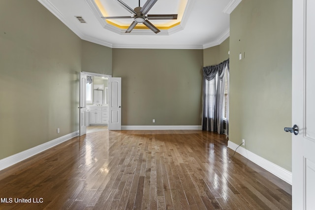 5578 E Diamondhead Dr, Diamondhead, MS 39525 - unfurnished room with a tray ceiling, crown molding, a ceiling fan, wood finished floors, and a high ceiling