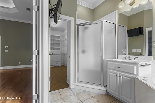 5578 E Diamondhead Dr, Diamondhead, MS 39525 - full bath with a shower stall, ornamental molding, vanity, wood finished floors, and a spacious closet