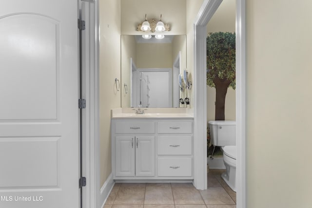 5578 E Diamondhead Dr, Diamondhead, MS 39525 - bathroom featuring toilet, vanity, tile patterned floors, and baseboards