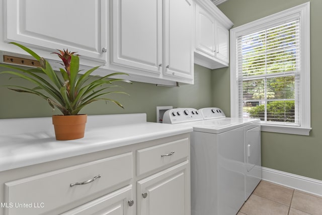 5578 E Diamondhead Dr, Diamondhead, MS 39525 - washroom with cabinet space, washer and dryer, light tile patterned flooring, and baseboards