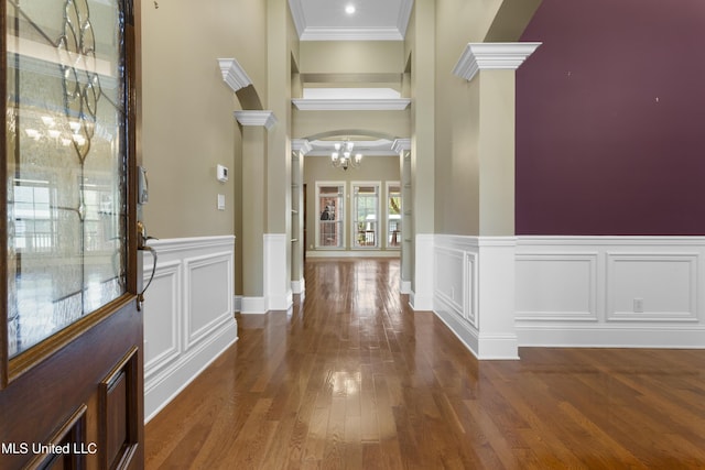 5578 E Diamondhead Dr, Diamondhead, MS 39525 - entryway with decorative columns, a chandelier, wood finished floors, ornamental molding, and a high ceiling